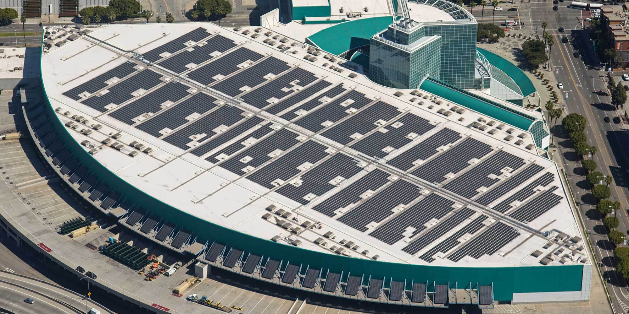 Semicircle business complex with teal accents and solar panels