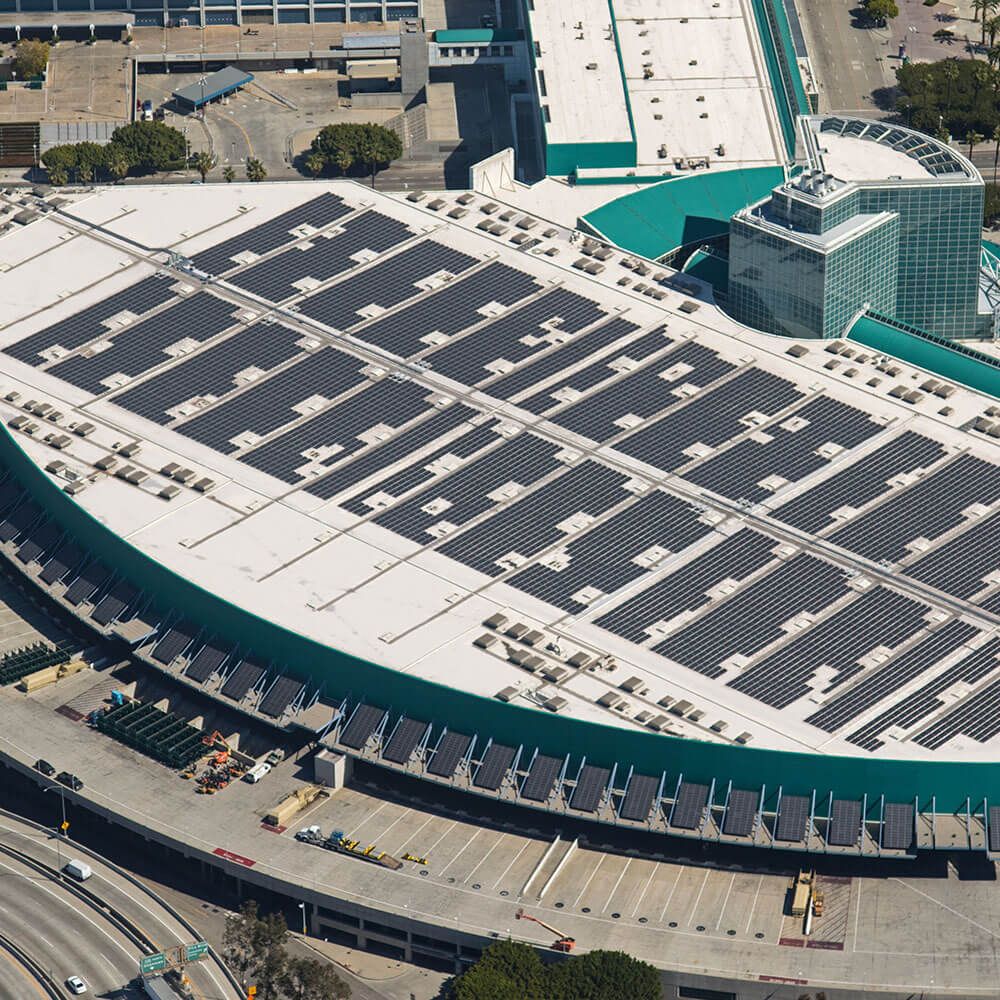 Semicircle business complex with teal accents and solar panels