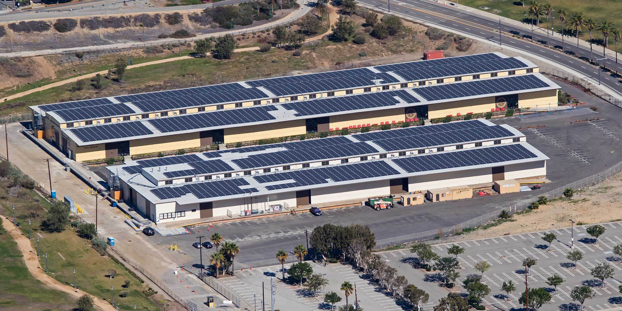 2 smaller commercial buildings with solar panels covering the roof