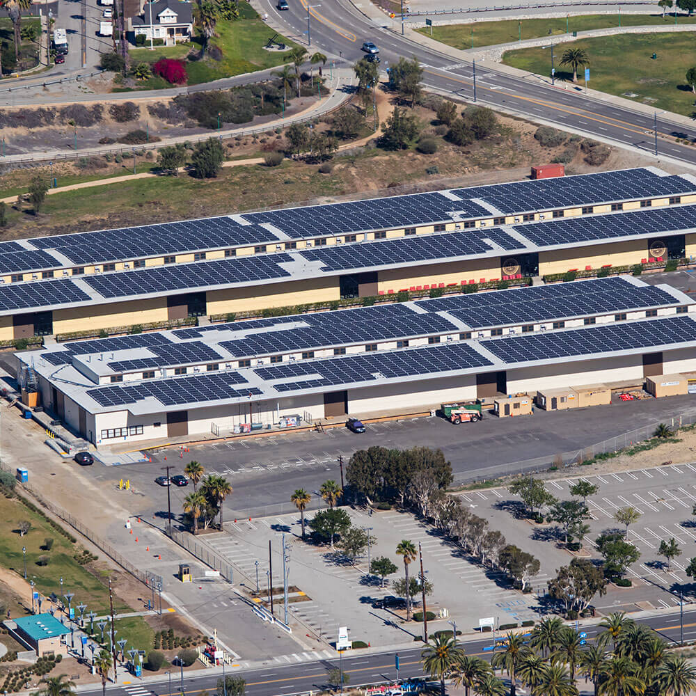 2 smaller commercial buildings with solar panels covering the roof