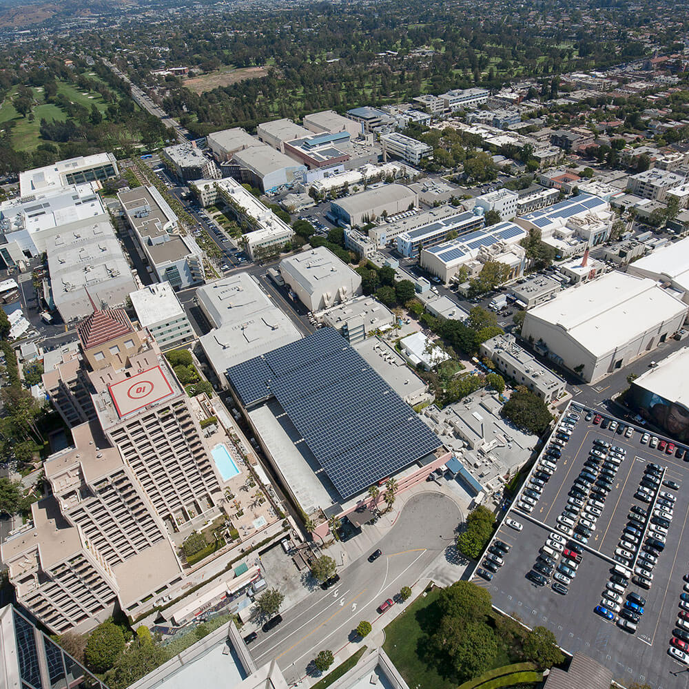 Aerial view of Fox Studios building with solar panels covering the roof