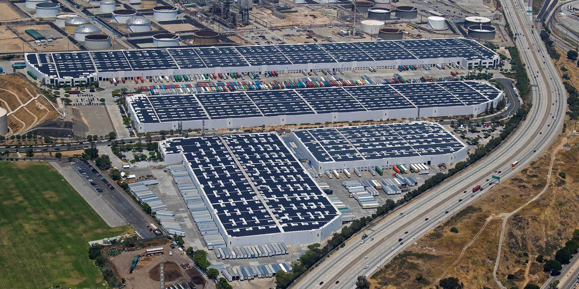Aerial view of large business complex with parked box trucks