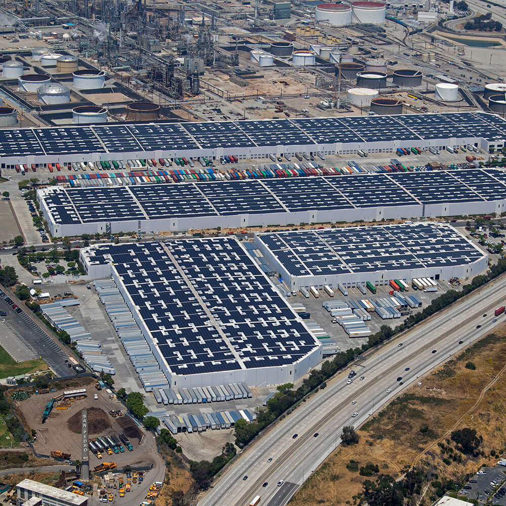 Aerial view of large business complex with parked box trucks