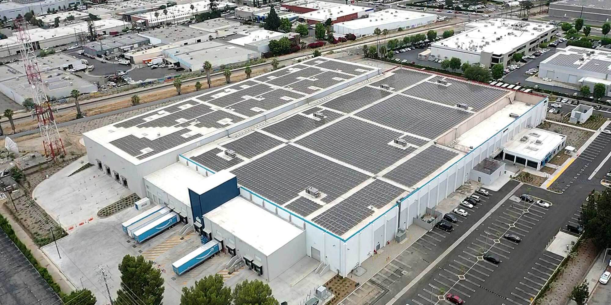 White commercial building with solar panels covering the rooftop