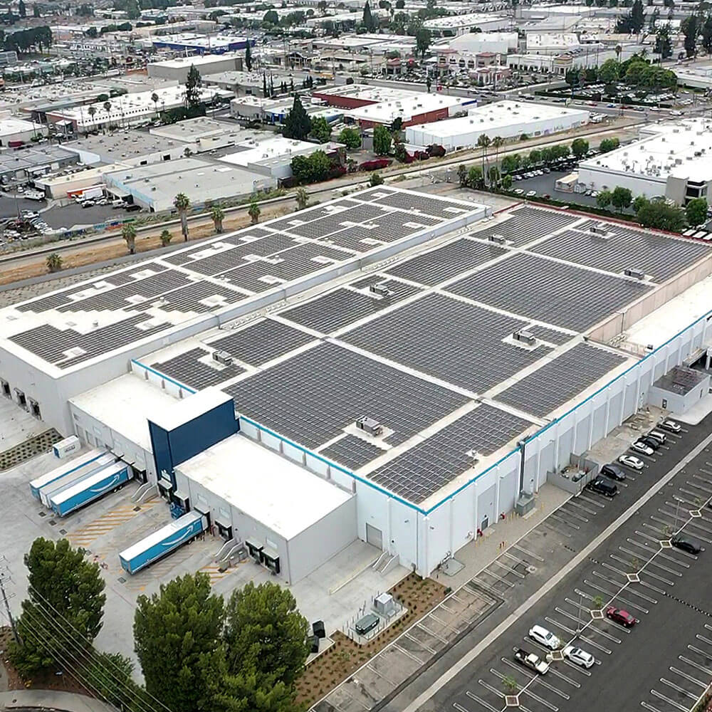 White commercial building with solar panels covering the rooftop