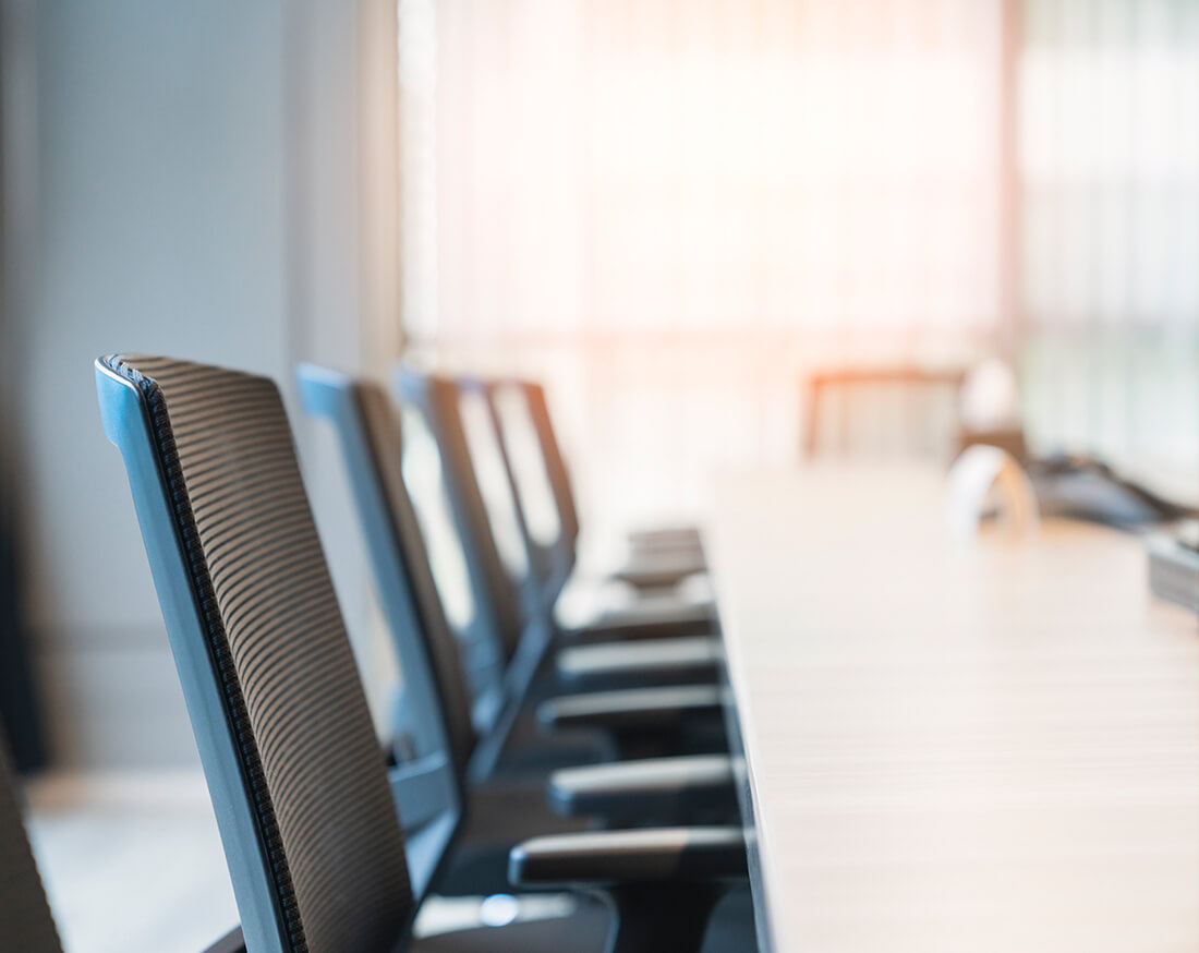 Clean, empty conference room with modern office chairs