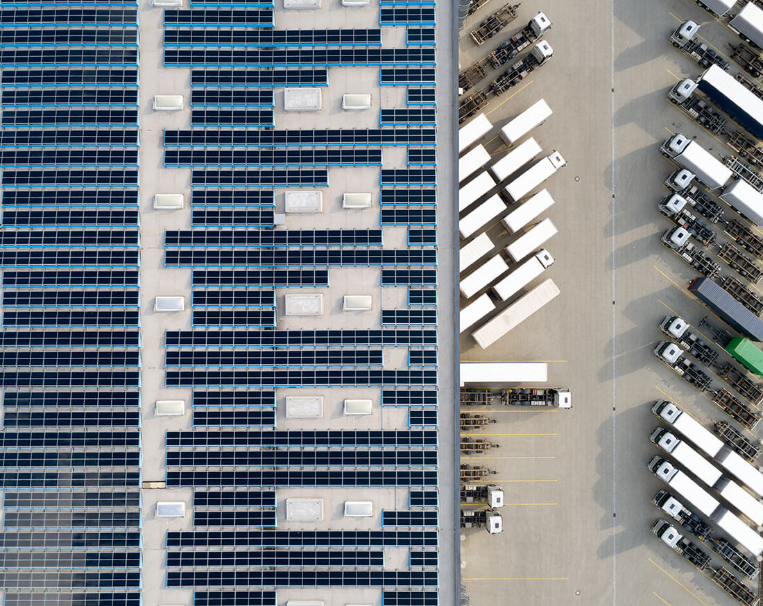 Bird's eye view of commercial building roof with solar panels